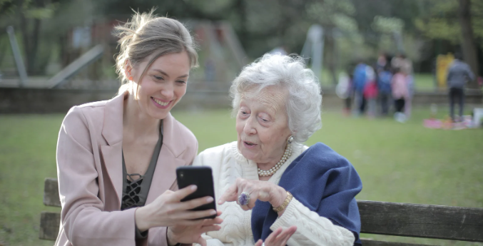 grandma, grand daughter, social media, photos, smartphone, park bench
