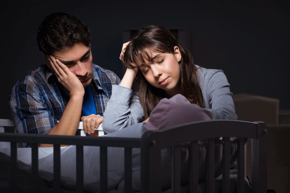 newborn baby, couple with baby, sad couple, crib, parents