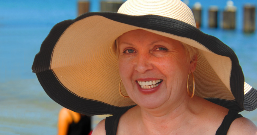 baby boomer, boomer grandma, boomer on vacation, sun hat, beach vacation