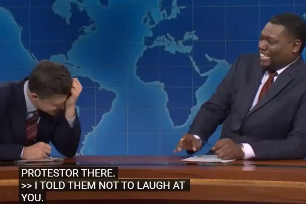 Colin Jost and Michael Che laughing on Weekend Update