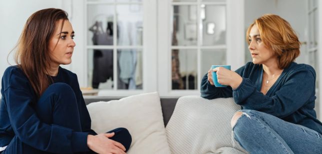 coffee, women having coffee, serious talk, women on couch, agreement