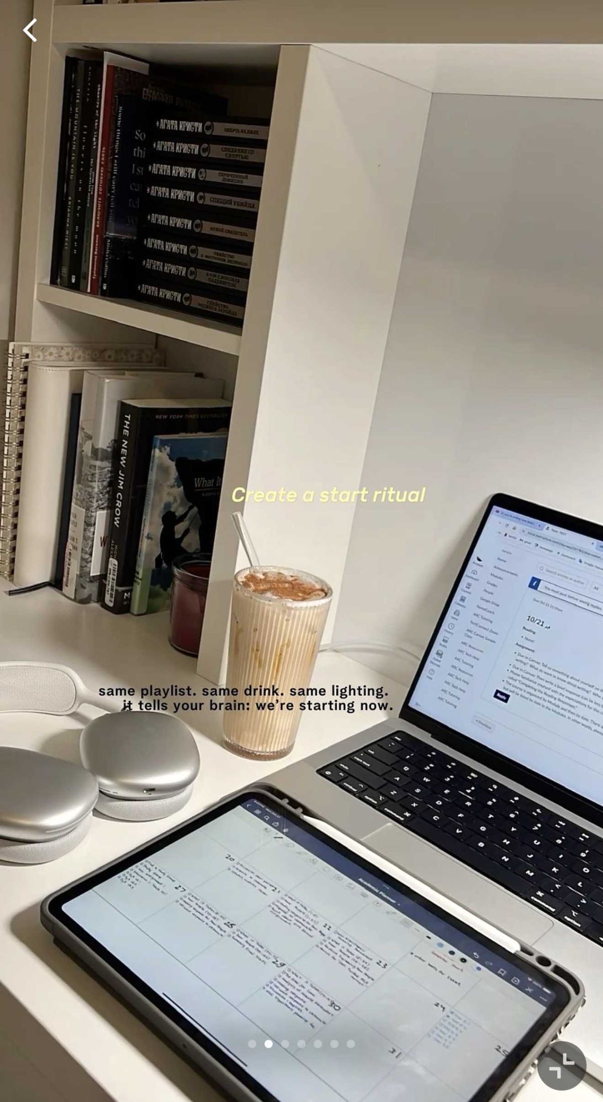 Desk, laptop, tablet, coffee, headphones, and books in a cozy study setup.