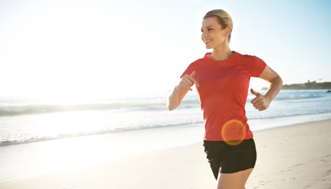 happy woman, energized woman, woman running, running on beach, feeling great