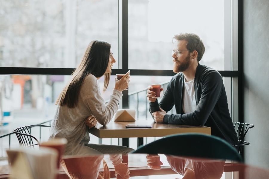 A couple engaged in conversation at a coffee shop