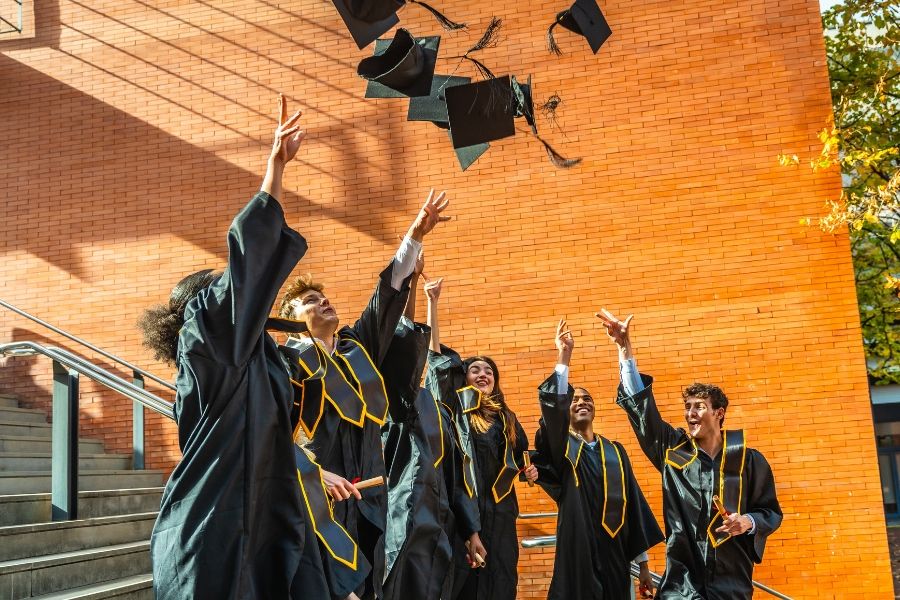 College students throwing caps at graduation
