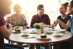 People engaged in fun conversation around a table