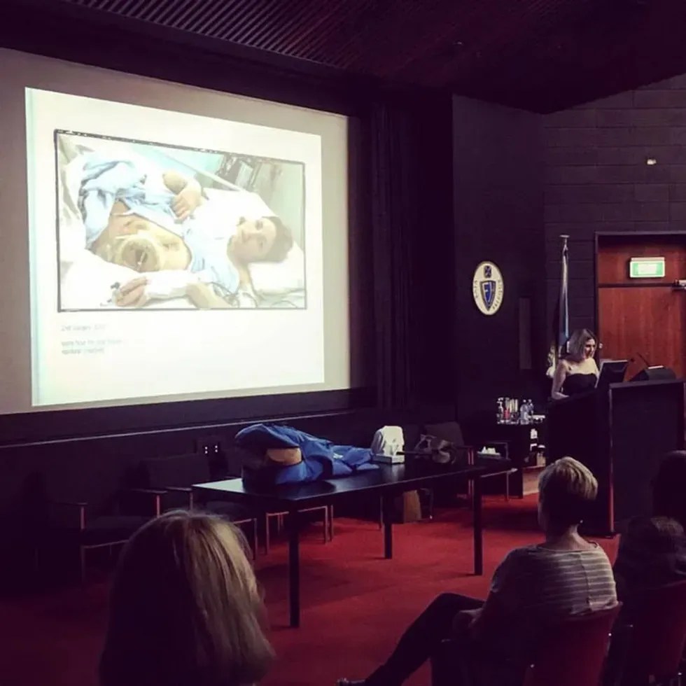 woman presenting to a crowd