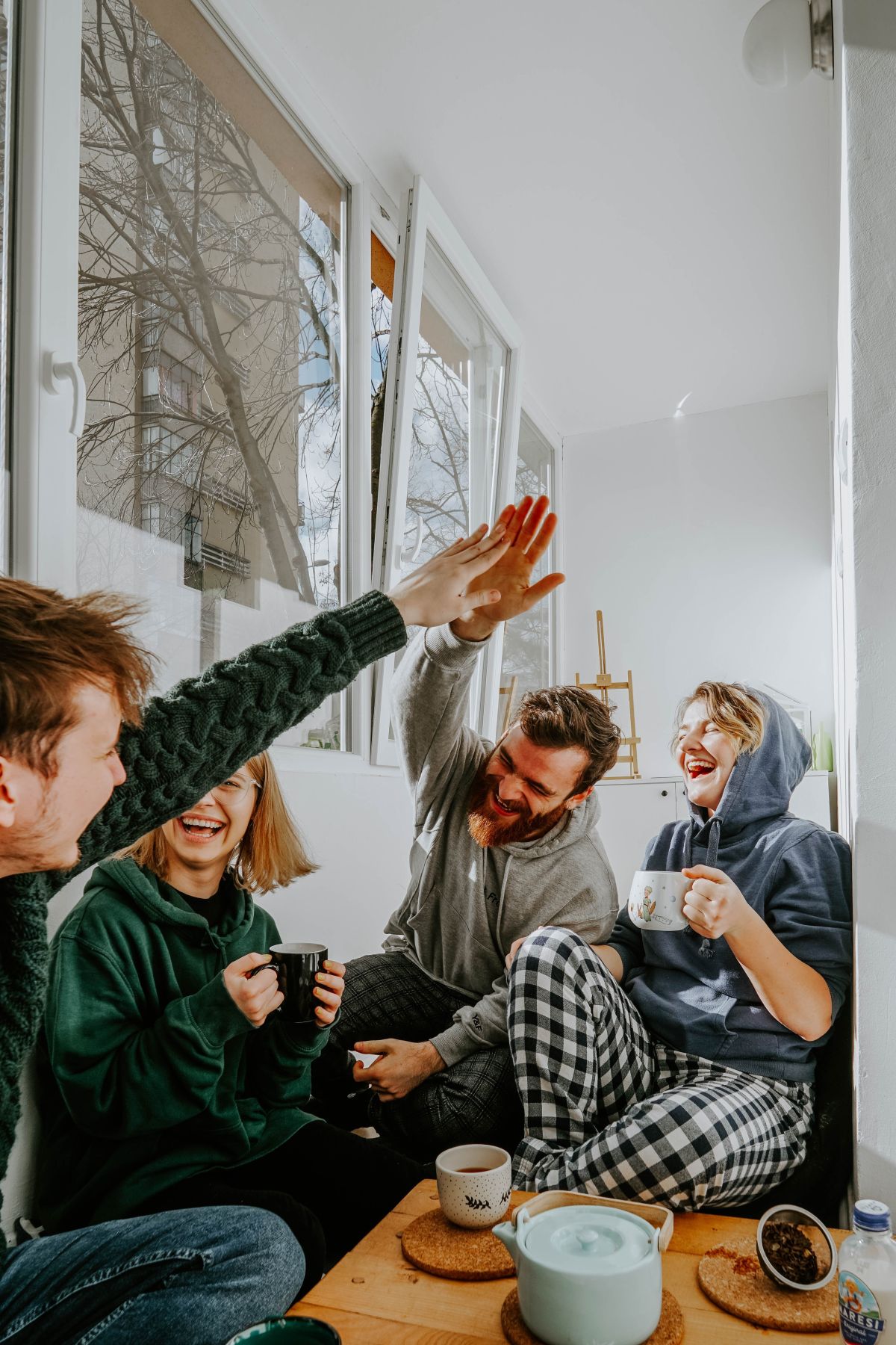 four friends laughing and hanging out