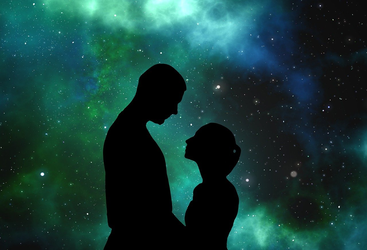 Silhouette of man and woman against stars