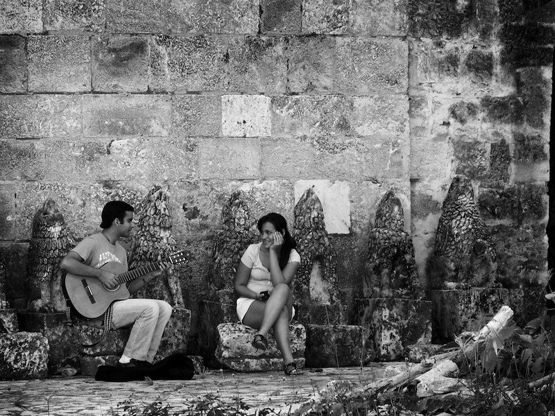 Man plays guitar for woman