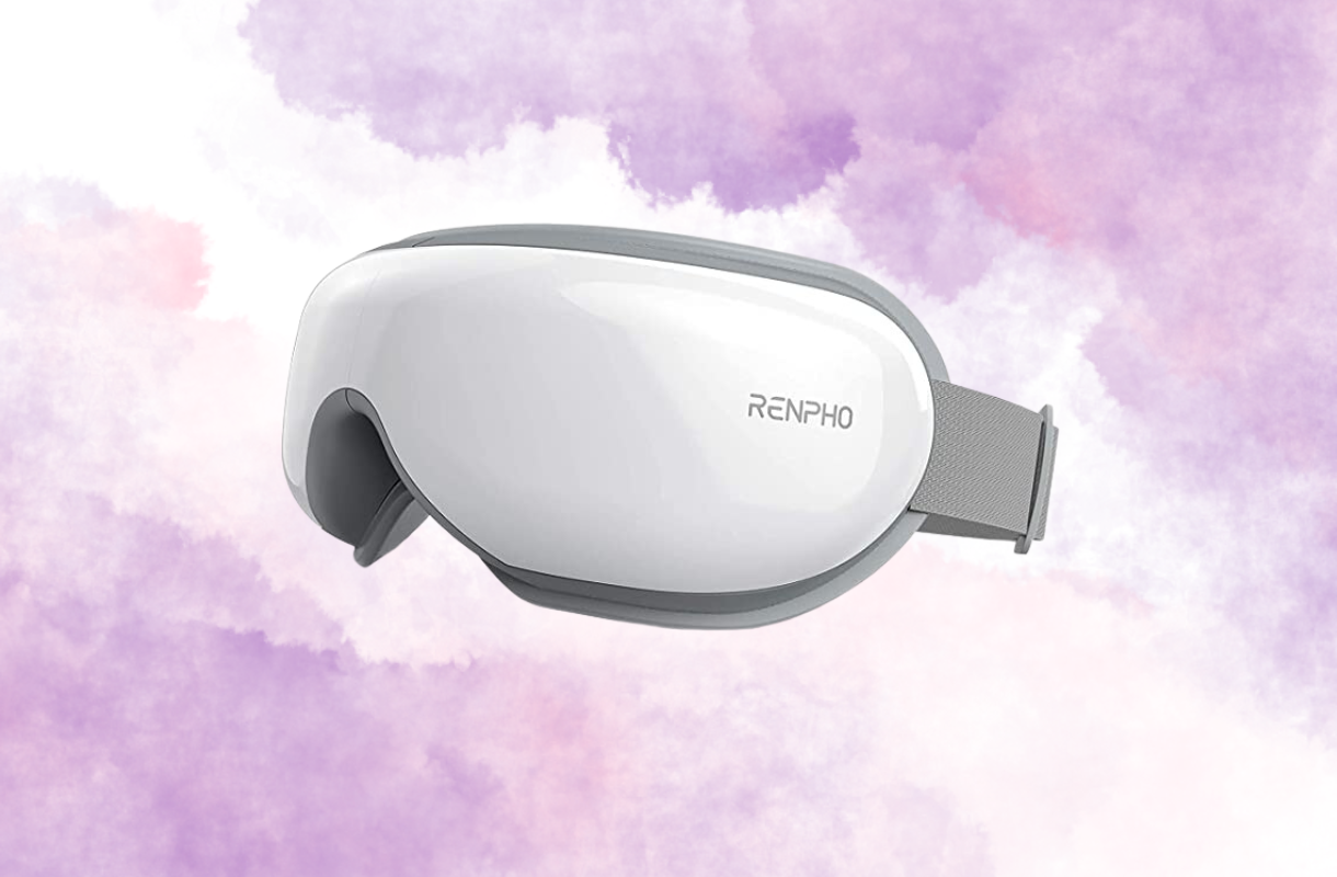 White Renpho eye massager with gray trim on a purple cloudy background.