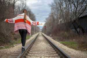 railroad tracks; rocks around train; train; cargo trains; rail road