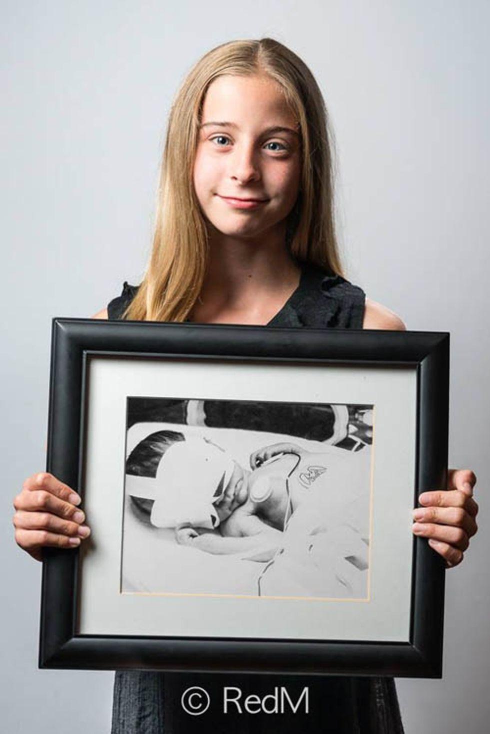 a girl holds a black and white photograph of herself as a premature baby