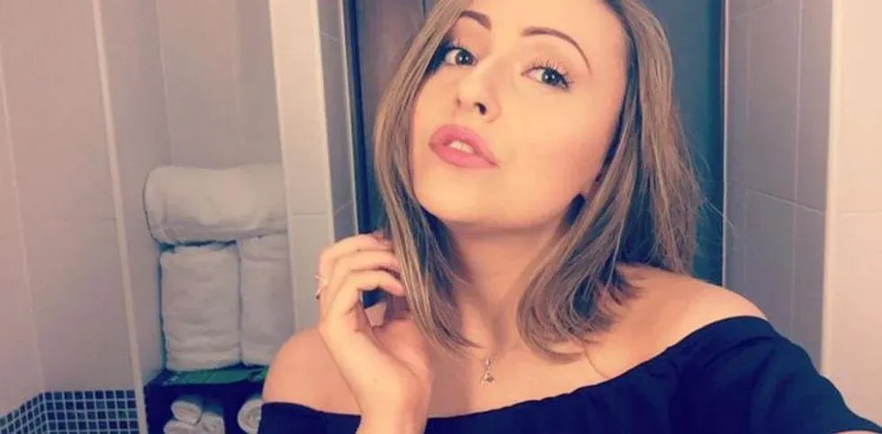 Woman poses in the mirror