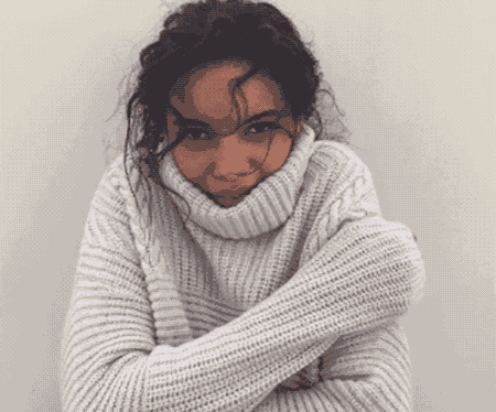 gif of shivering woman in sweater