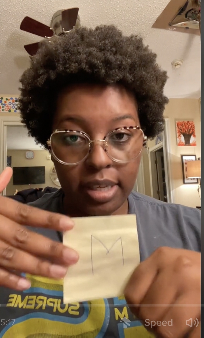 screenshot of woman in glasses speaking to camera