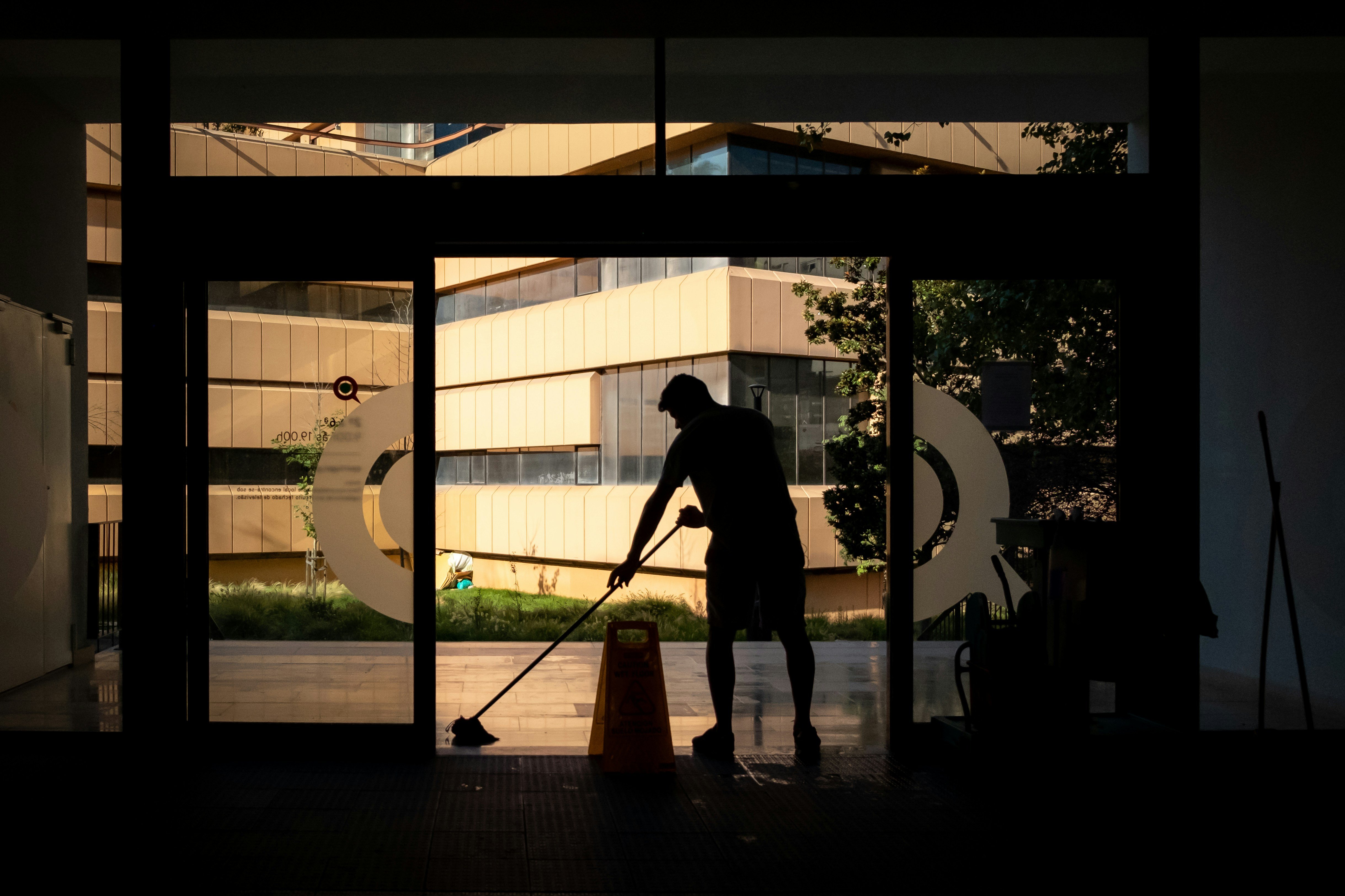man cleaning a floor with a mop