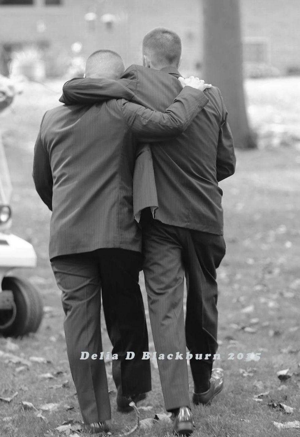two men with their arms around each other's shoulders