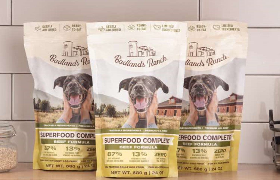 Badlands Ranch dog food bags on a kitchen counter with a dog image.