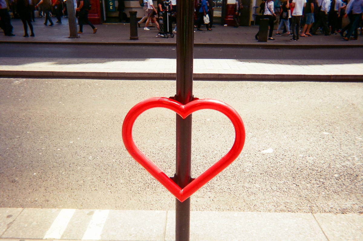 a bike rack shaped like a heart overlooking a street