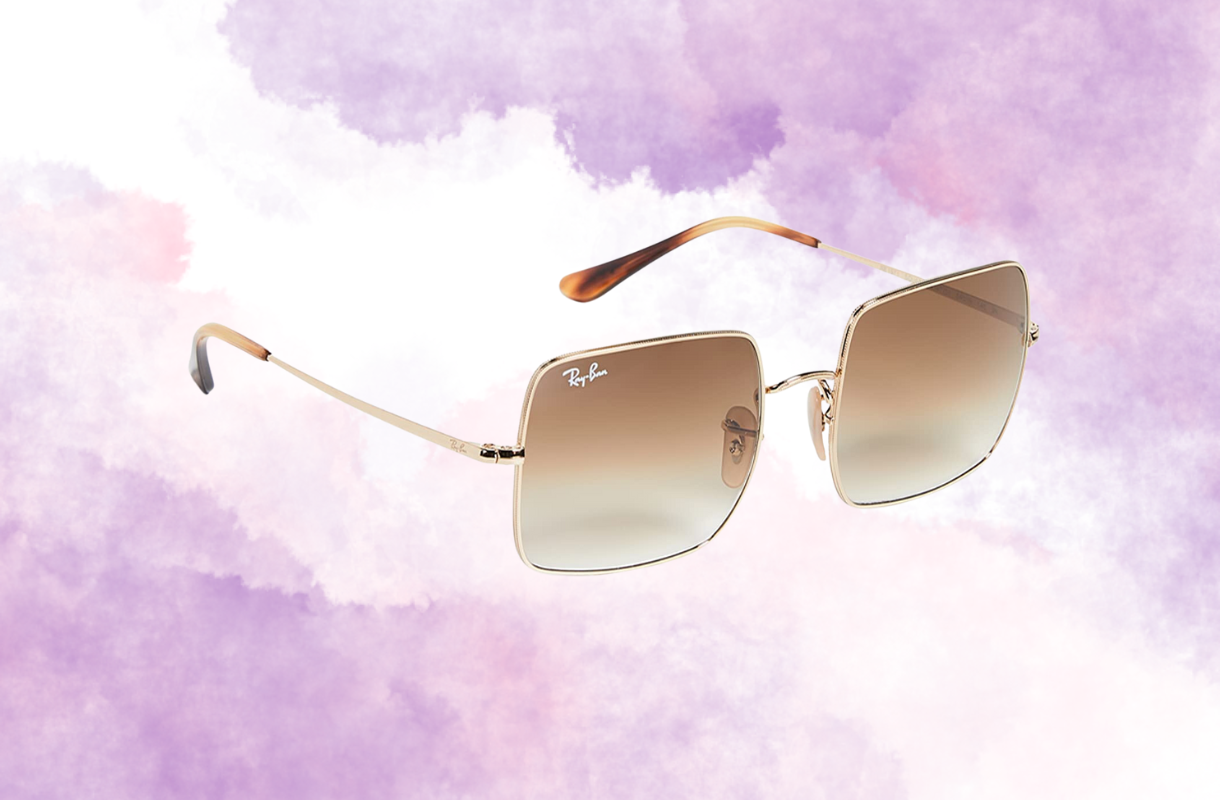 Square sunglasses with gold frames on a purple watercolor background.