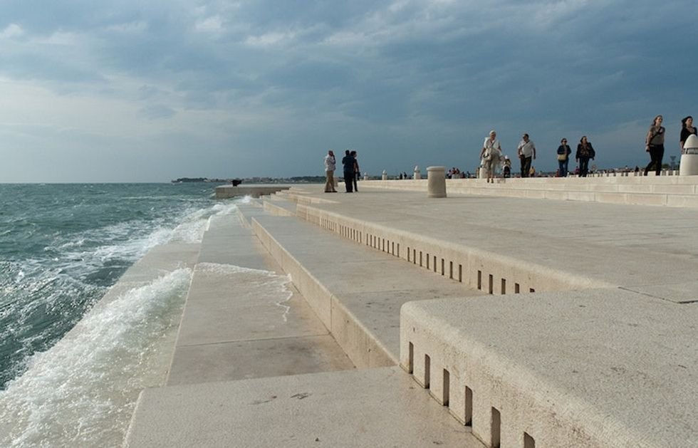 people standing on the sea organ