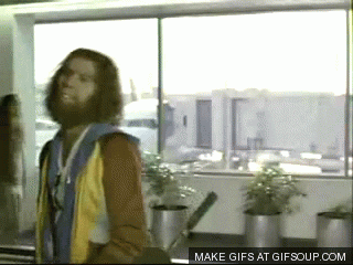 gif of caveman at airport