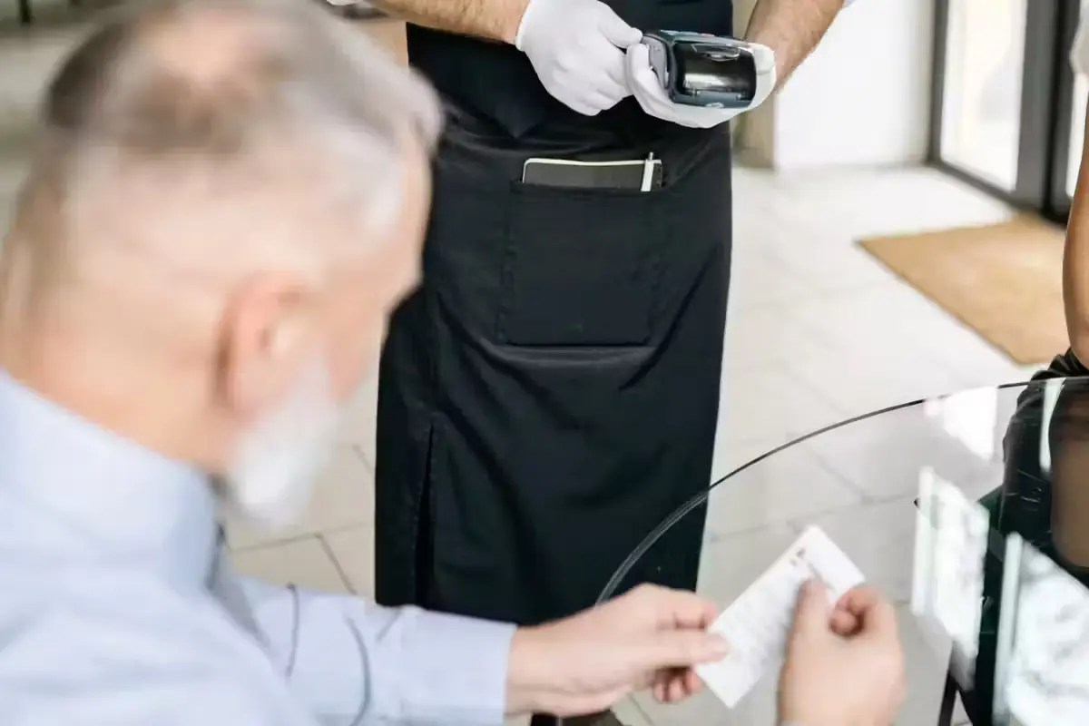 A restaurant customer looks at his bill