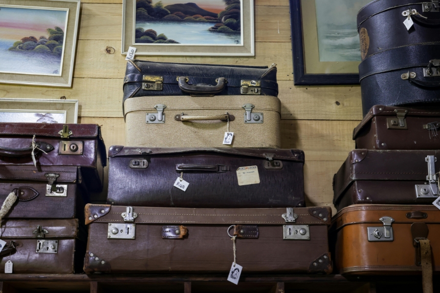 A stack of vintage suitcases from before luggage had wheels