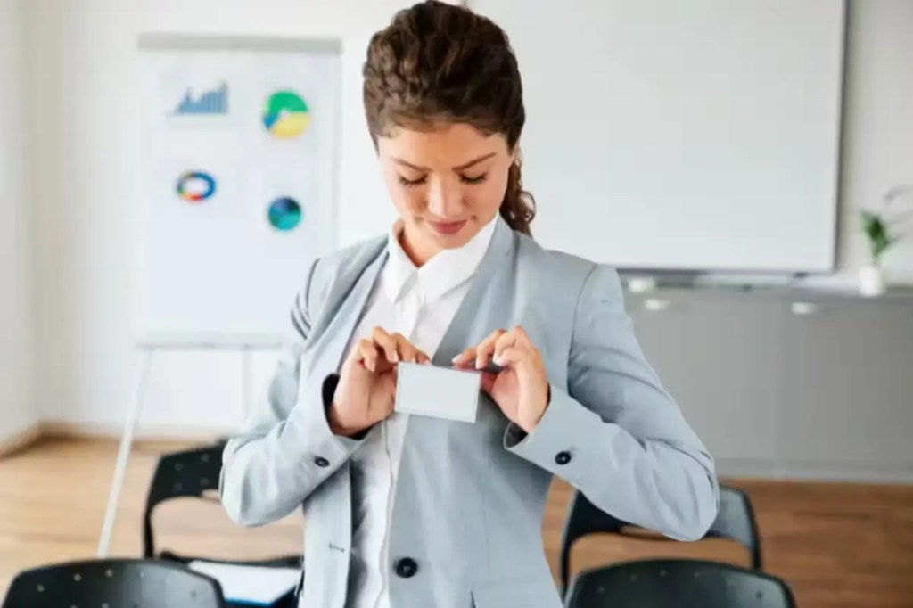 Young person attaching a name tag on their lapel