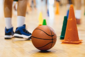 A basketball sitting on the floor of a school gym