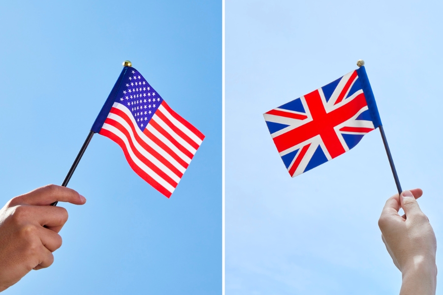 A person holding an American flag and a person holding a British flag