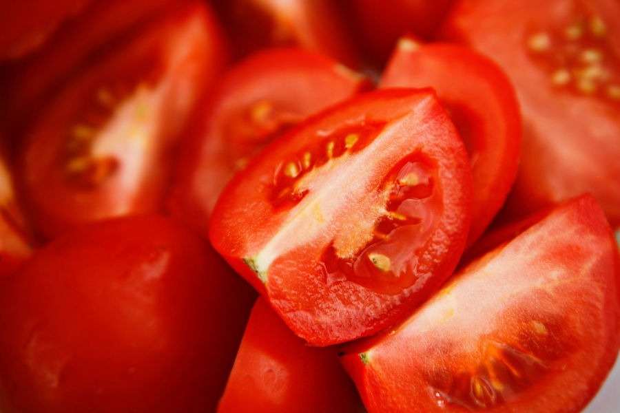A close-up photo of red, ripe sliced tomatoes.