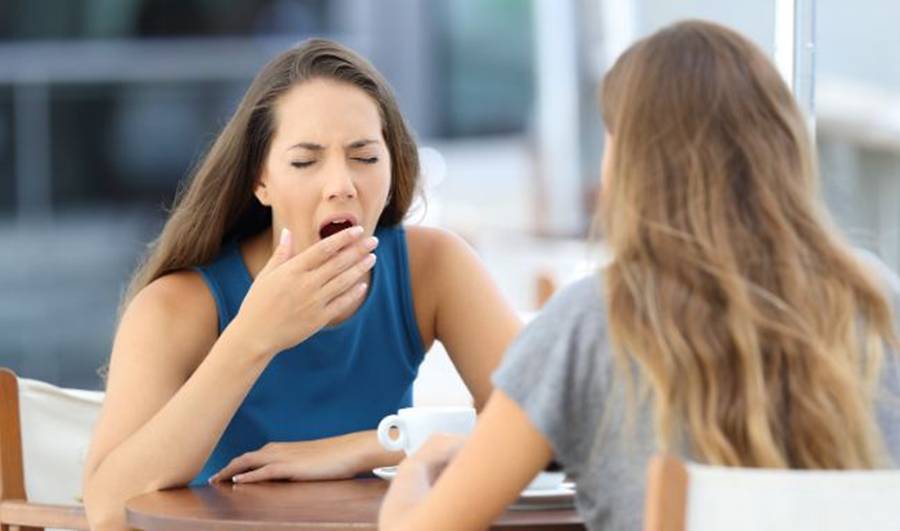 women chatting, yawn, tired, bored, woman in blue