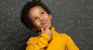 smart kid, thoughtful kid, kid with an idea, kid holding chin, chalk board