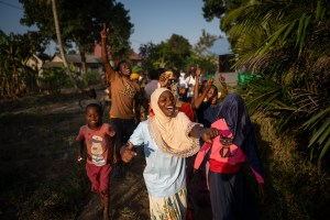 Image of young Tanzanian children laughing and cheering