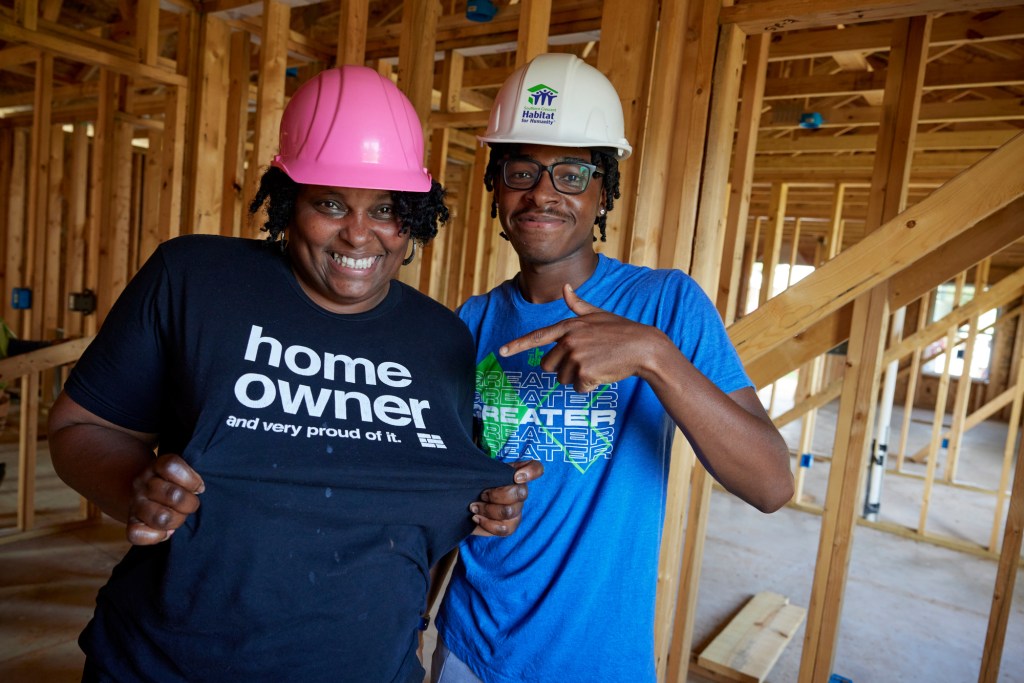 Marsha and her son pose for a photo while building their future home with Southern Crescent Habitat for Humanity in Georgia.