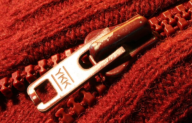 Red sweater with a YKK zipper closeup