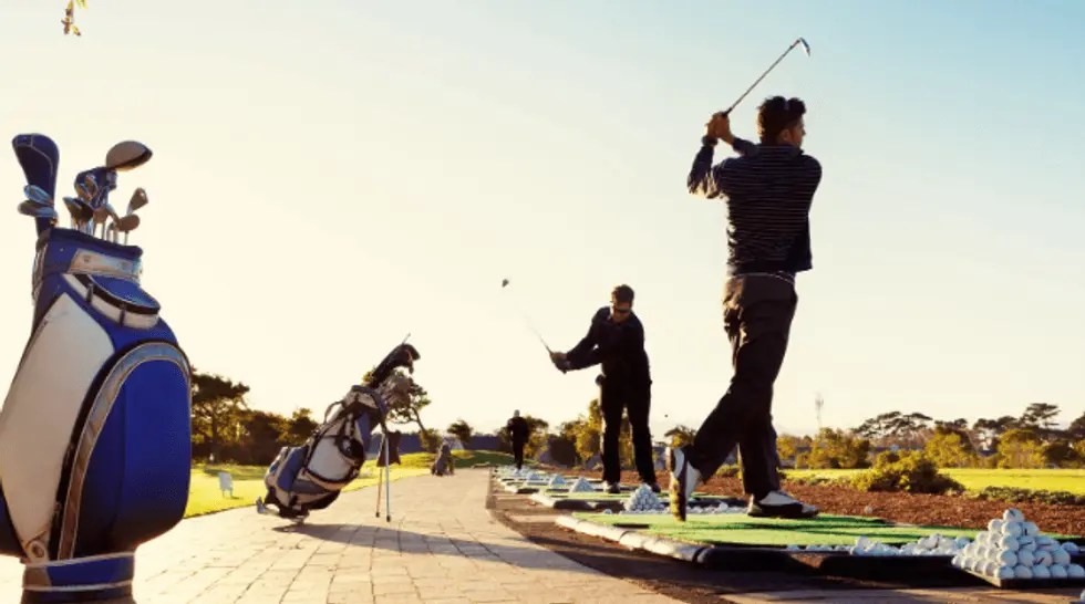 People practicing on the driving range.
