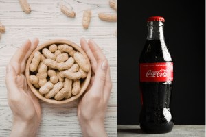 A person holding a bowl of peanuts and a bottle of Coca-Cola