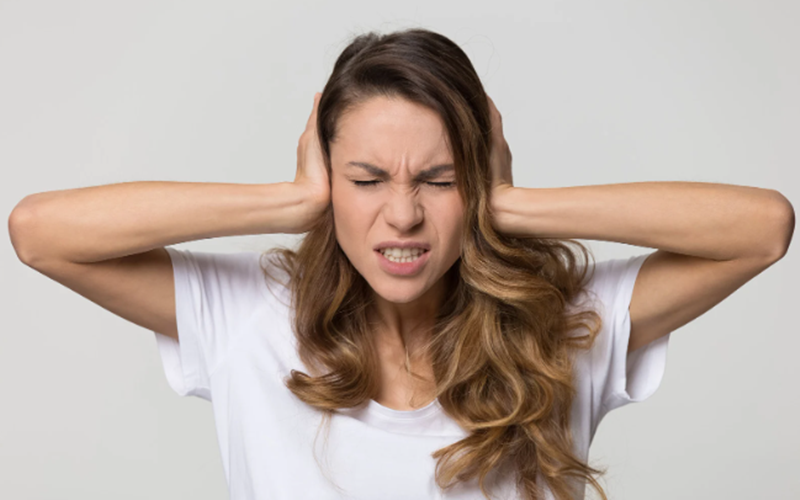 estranged, no contact, woman plugging ears, frustrated woman, brown hair