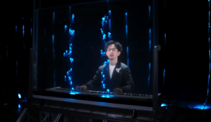 Man plays a piano while watching bioluminescent algae dance in bubbles