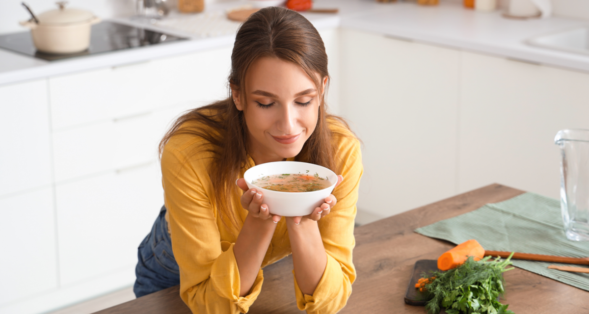 soup, woman eating soup, woman in kitchen, carrots, breakfast