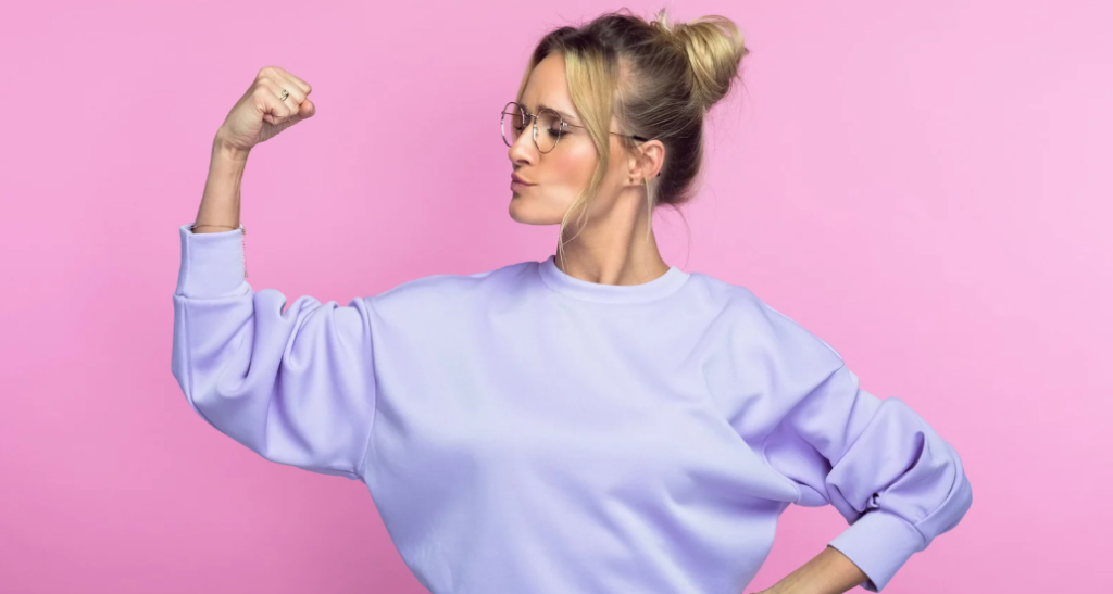 confident woman, flexing woman, strong woman, self-assured woman, woman in sweatdhirt