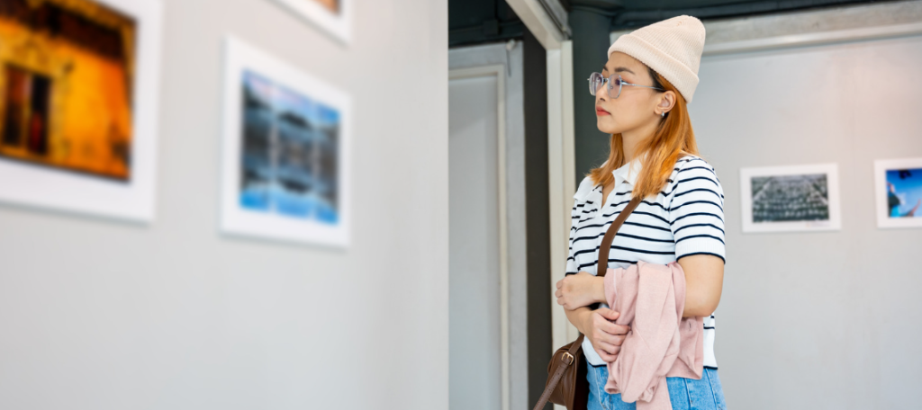 art gallery, woman in art gallery, looking at paintings, woman in beanie, artistic woman