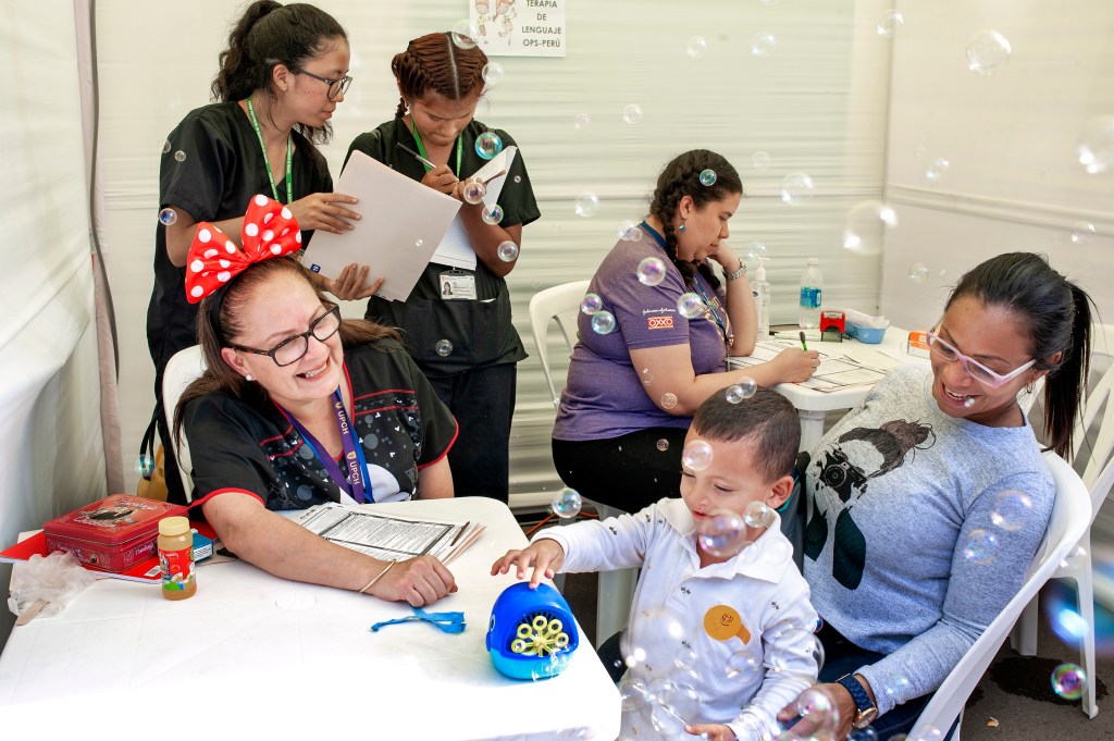 Milagros Rojas, a volunteer speech therapist in Peru, using bubbles in a screening with a patient. (Operation Smile Photos) 