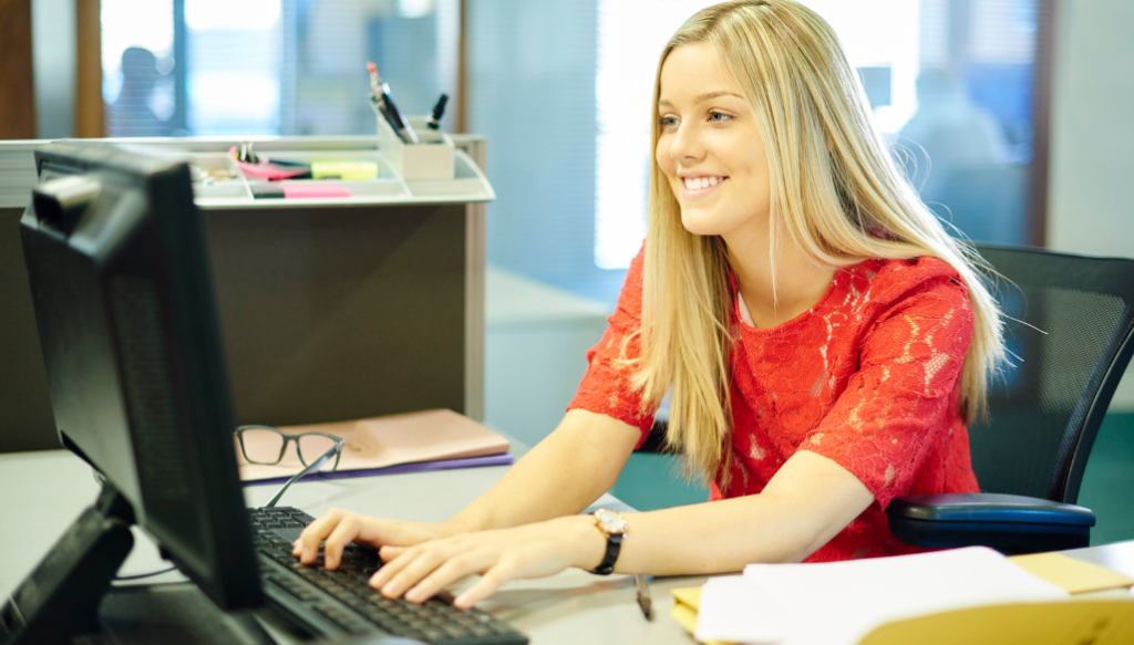 office worker, working woman, woman at computer, woman red bouse, smiling woman