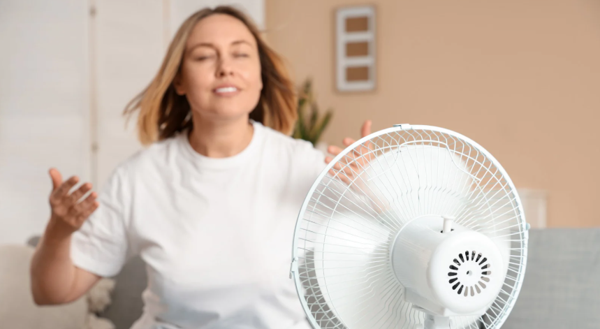 woman and fan, hot day, rotating fan, hot room, cool woman