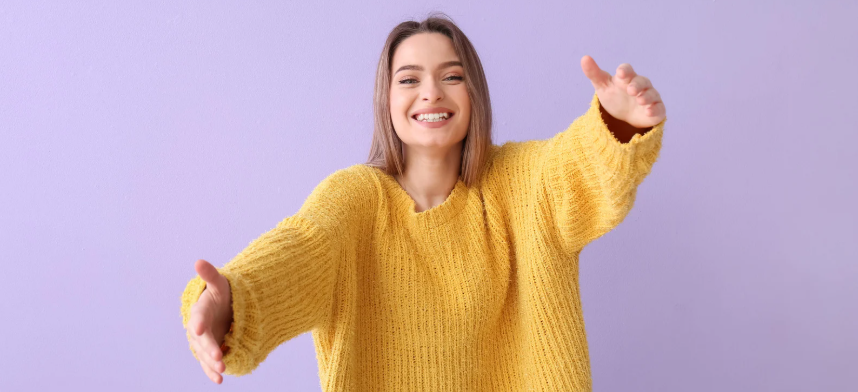 hugs, woman hugging, arms outstretched, woman in sweater, a big hug