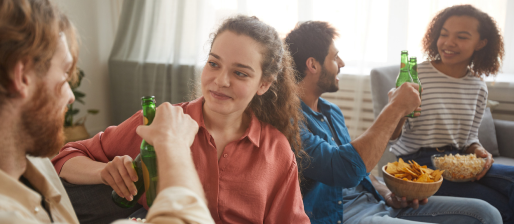 cheers, raise a glass, party, chips, people on couch, drinking beer